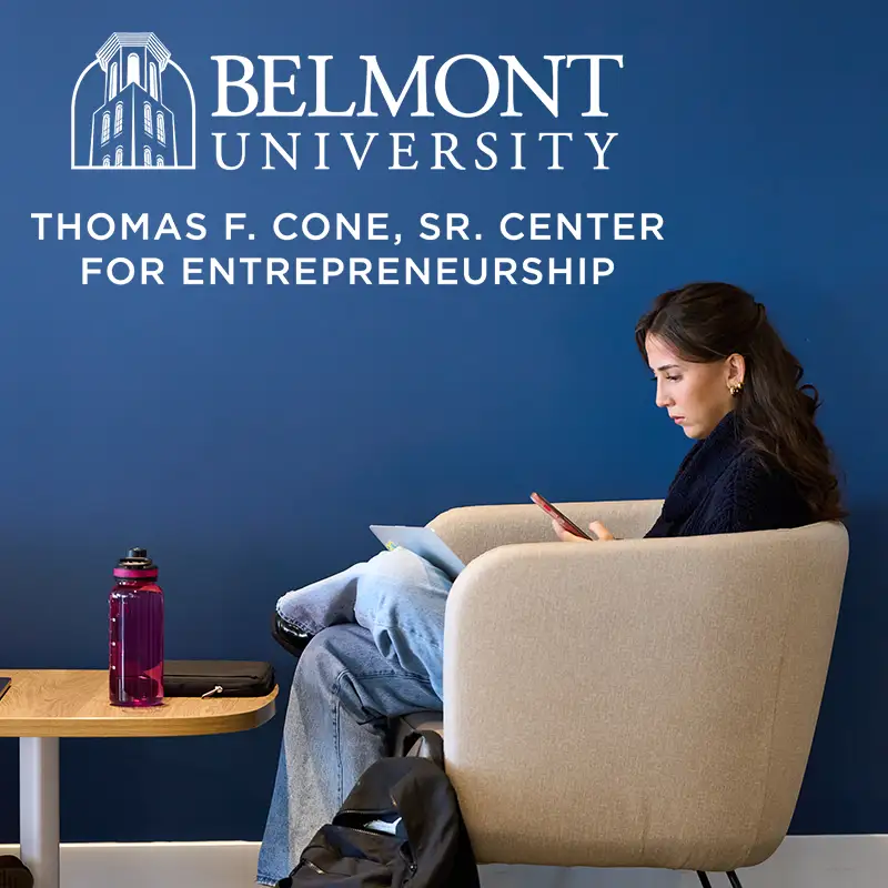 The Cone Center for Entrepreneurship logo above a student looking at her phone in a comfy chair