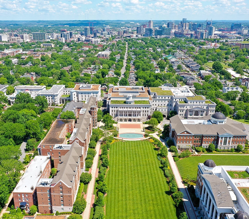 An aerial photo taken by a drone of Belmont and the Belmont University lawn with the Nashville skyline in the background