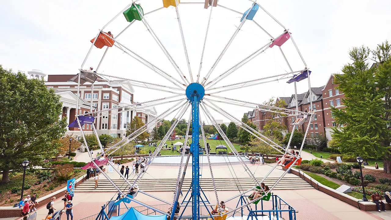 A Ferris wheel set up during Belmont's Day to Dream event, with students enjoying rides and activities in the background.