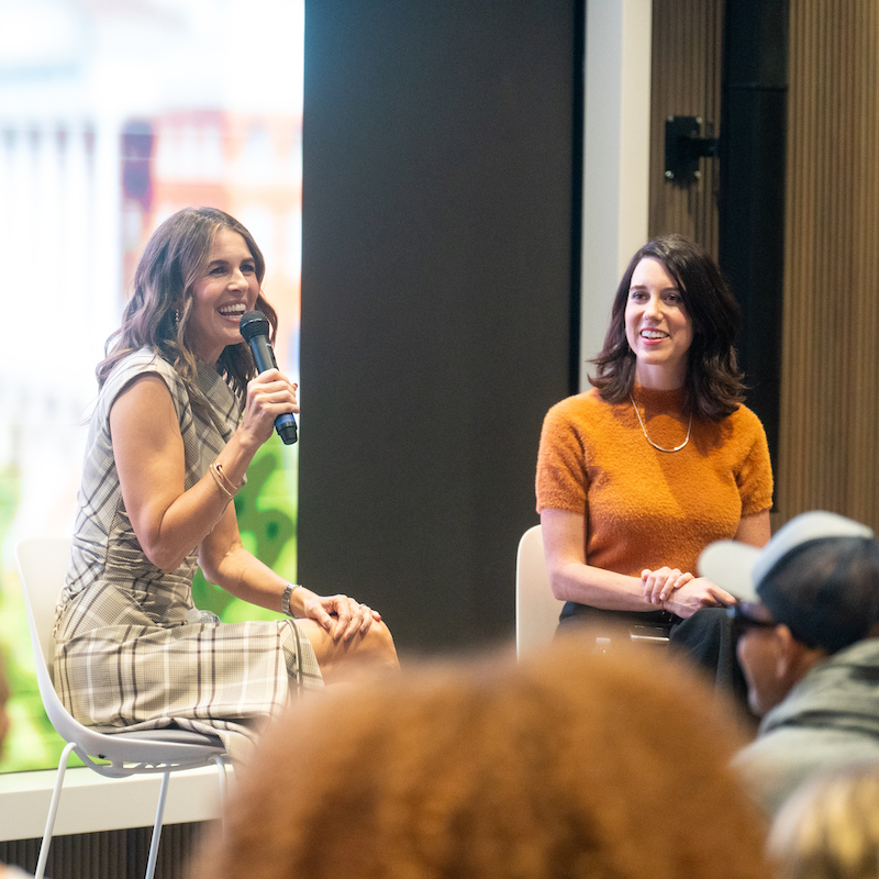 Two female speakers hold a microphone during Big Idea week.