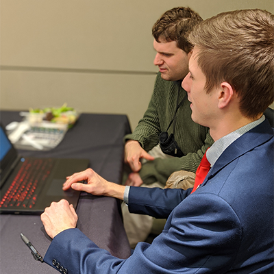 Student working a prospective employer at a laptop