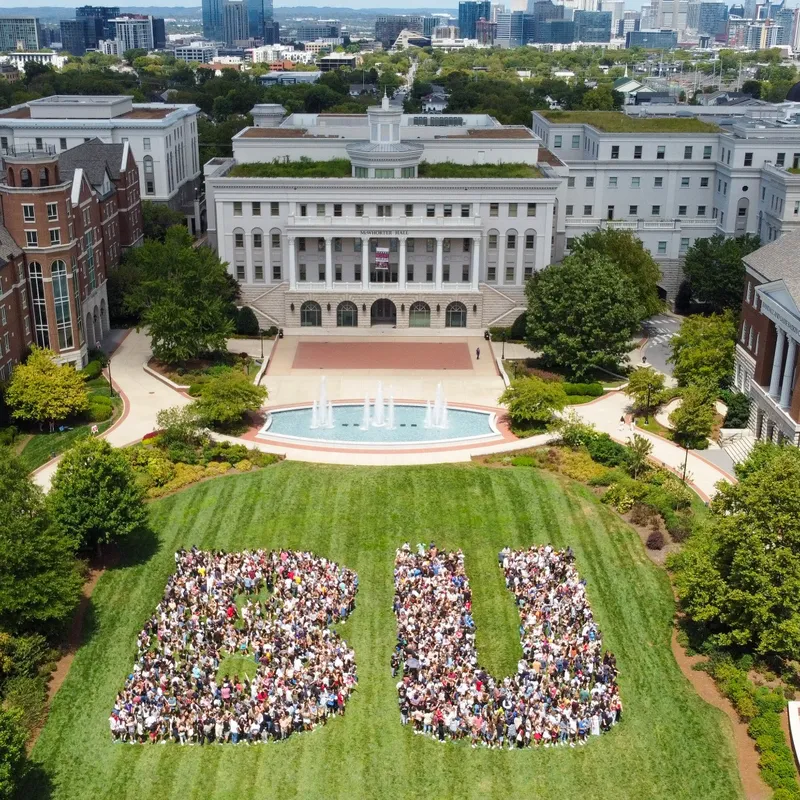 Drone shot of campus with students forming the letters B U