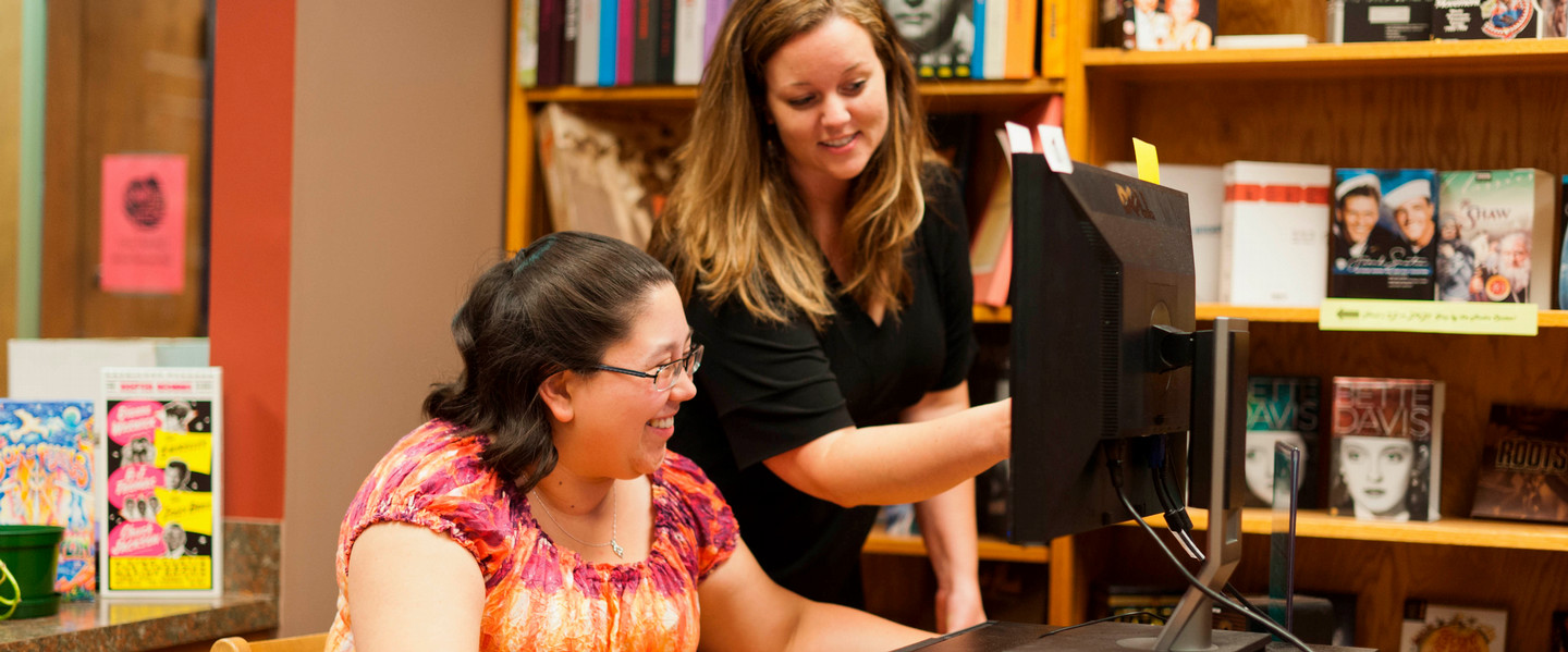 Claire Wiley assisting a student with her questions