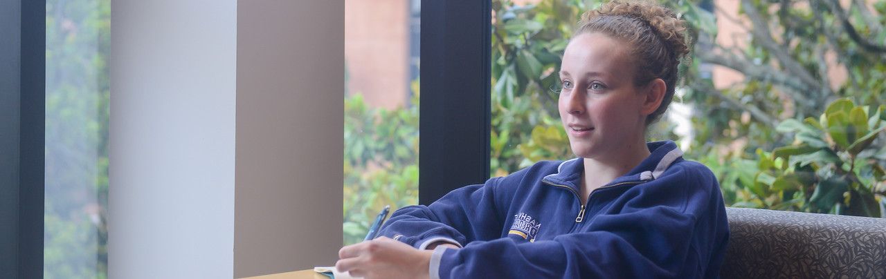 Student enjoying studying at Lila D Bunch Library.