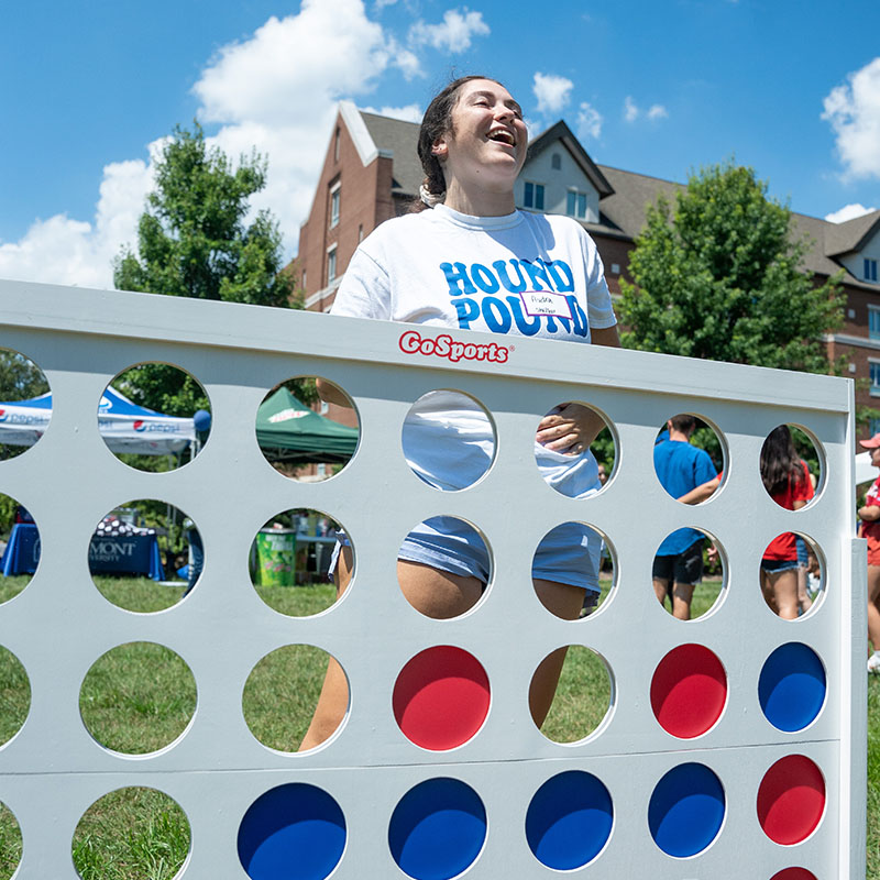 A student playing a giant game of connect 4