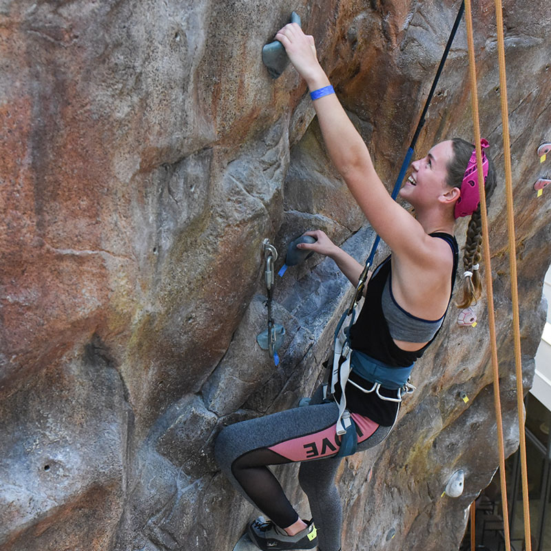Student climbing the rock wall