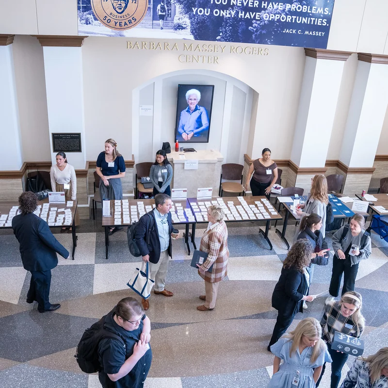 Students, faculty and guests gather in the Barbara Massey Rogers Center lobby during a Massey College of Business event.