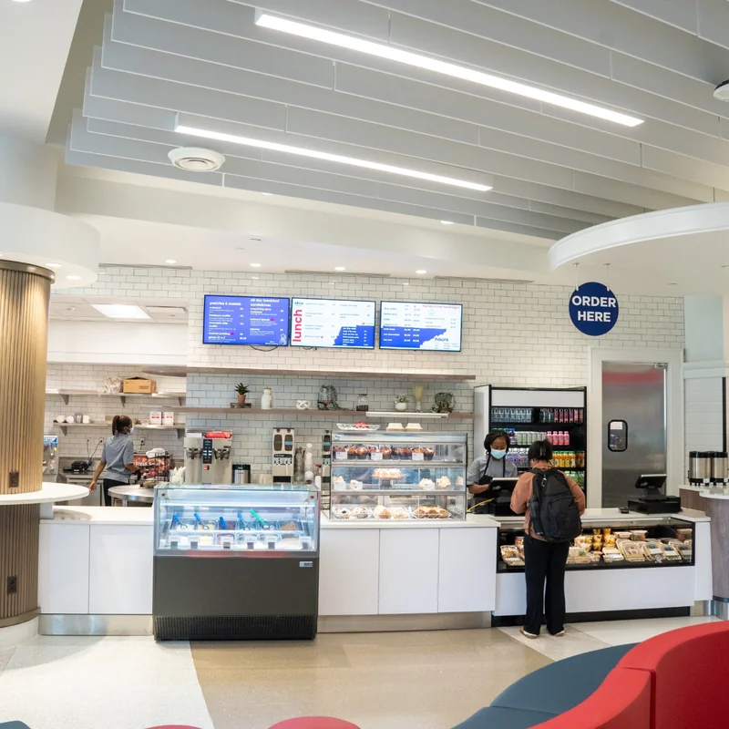 Café and seating area inside the Jack C. Massey Center with students ordering food and meeting.