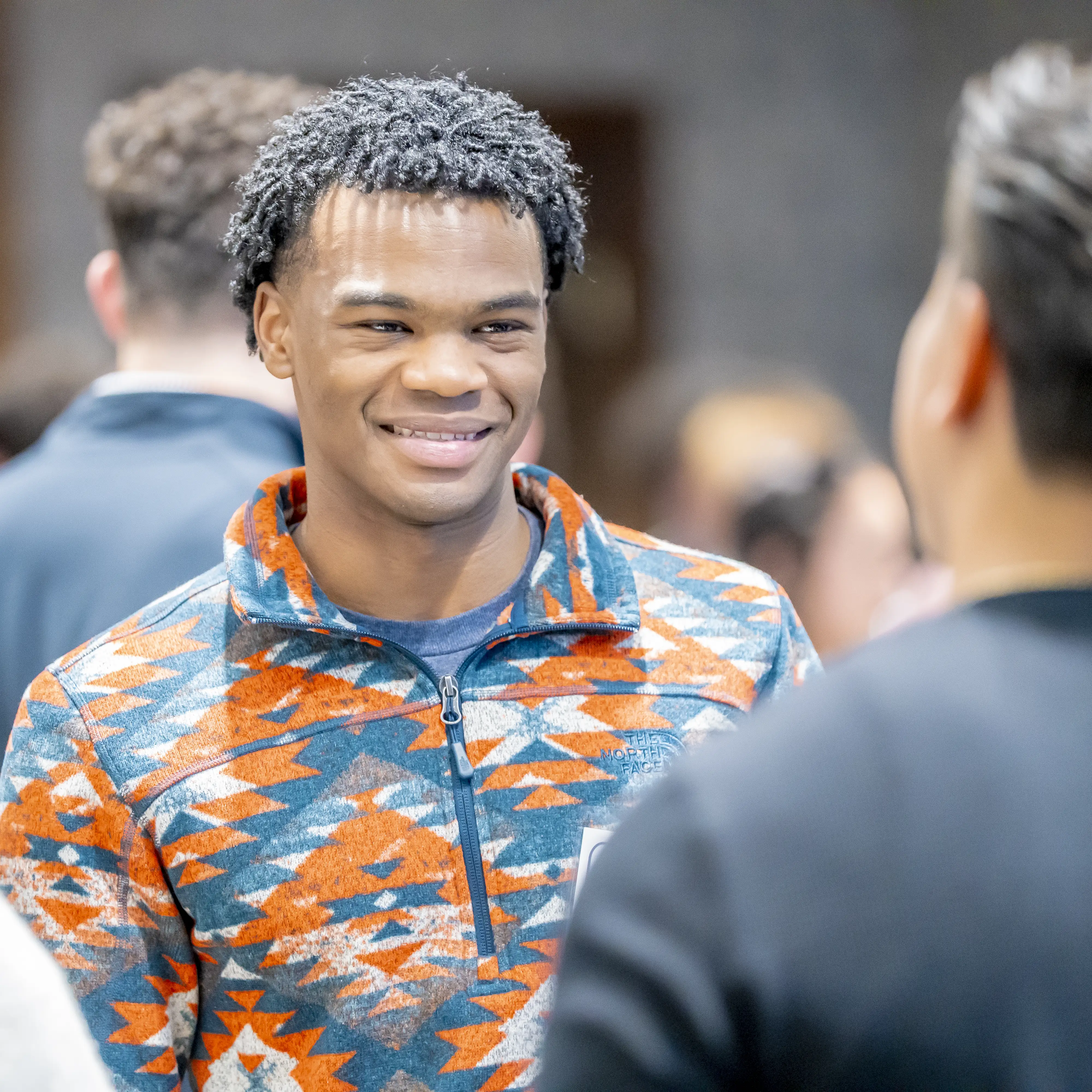 Employer representative shaking hands with a student during a campus networking event.