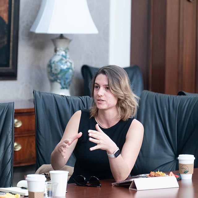 Student participating in discussion at a conference table