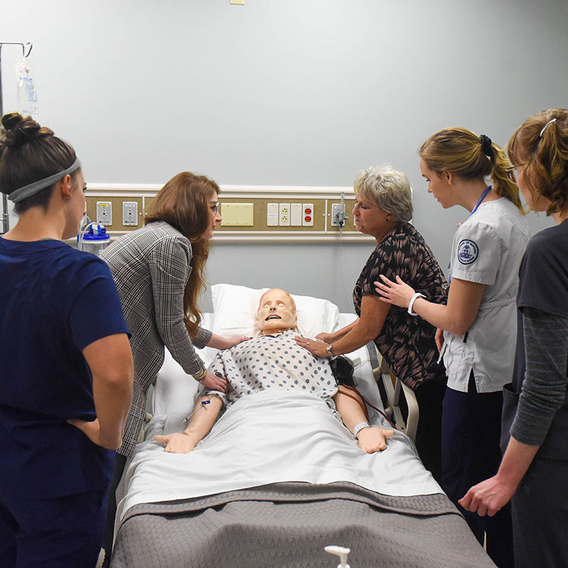 Health care students work together in an interprofessional end of life simulation