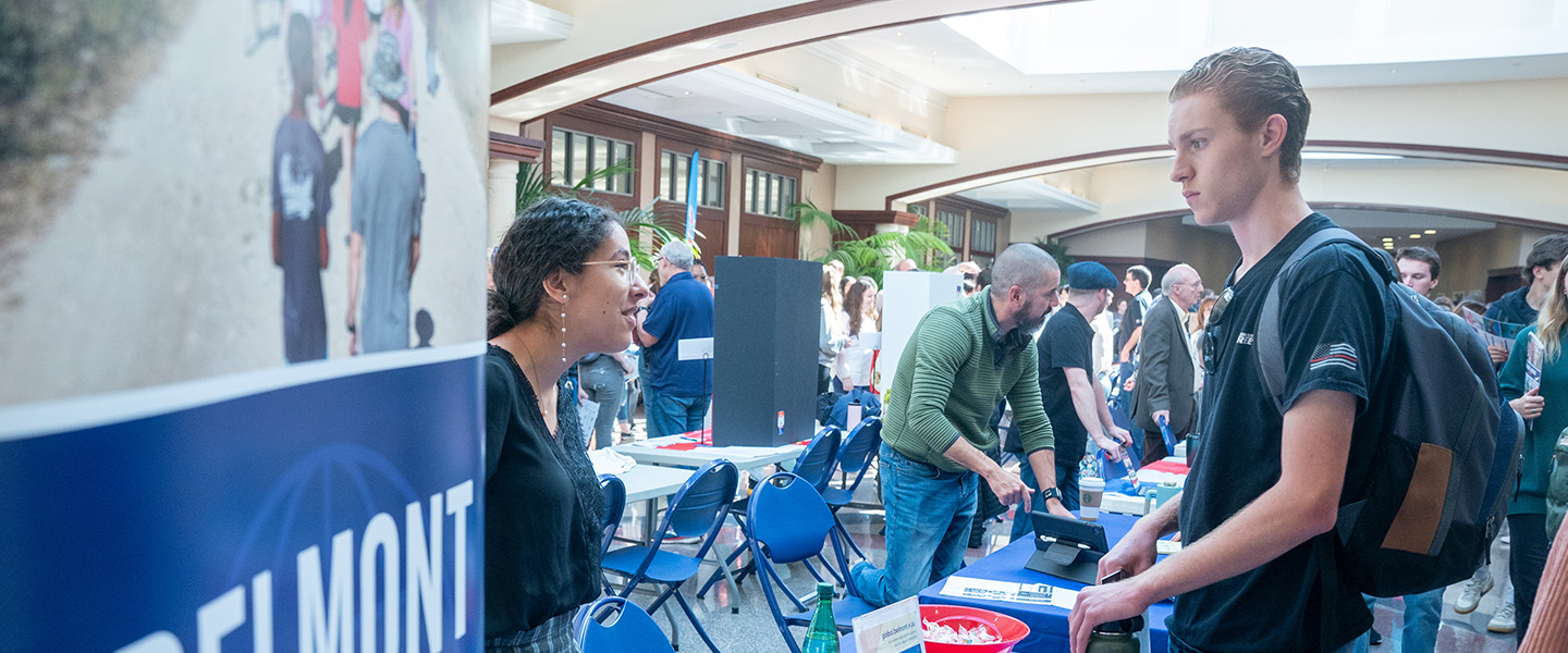 A student stops by the Belmont on Mission desk at a student fair.