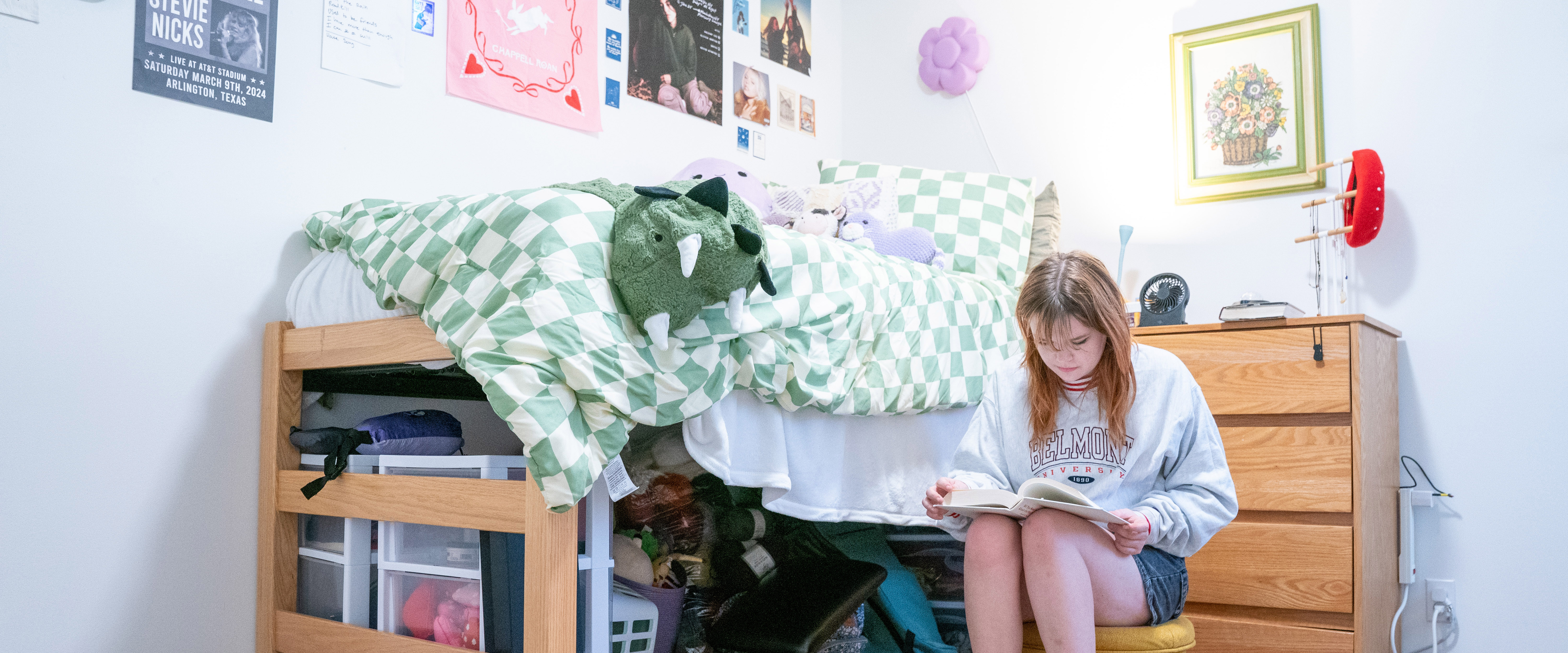 Student sitting in their dorm room reading a book