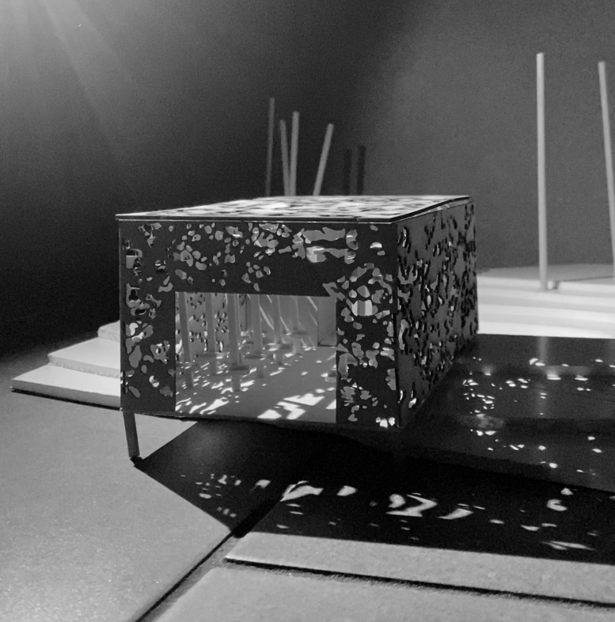 model of the inside of a building in a black box with dappled light inside from an angle