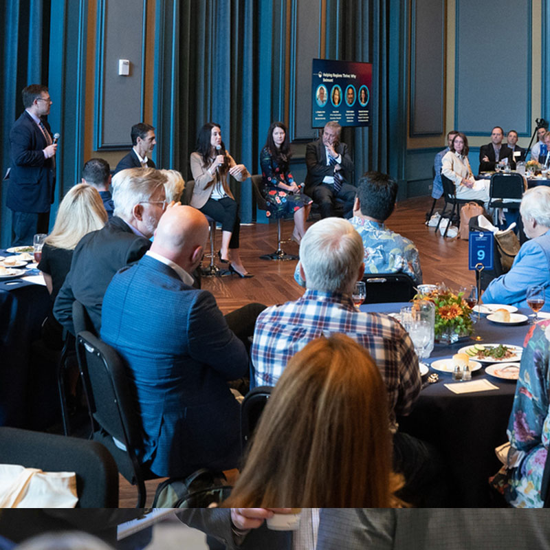 A panel giving a talk at a networking event