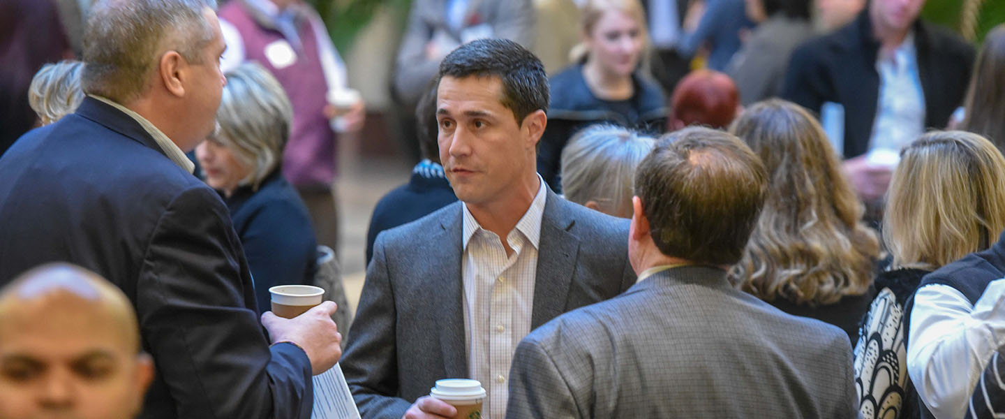 Business man talks with a colleague at a networking event