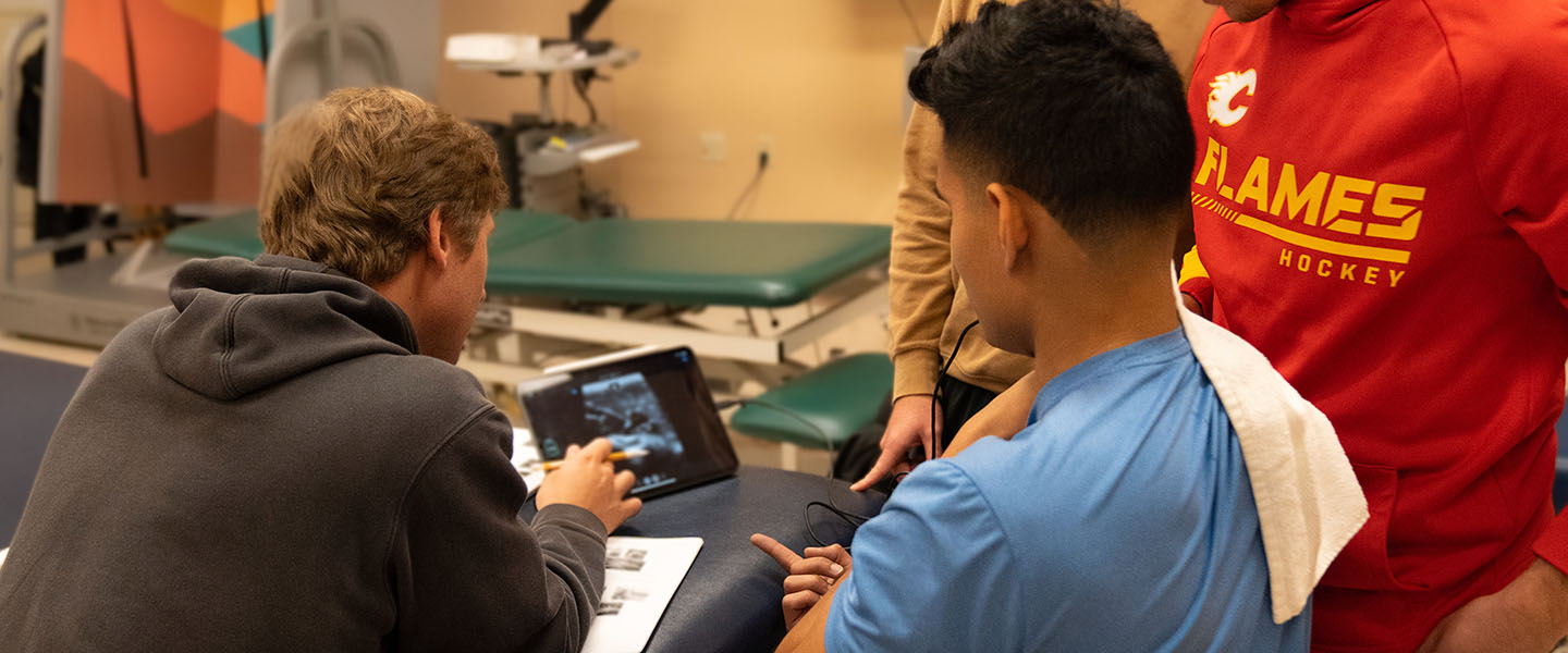 Physical Therapy students working with an ultrasound machine in a lab