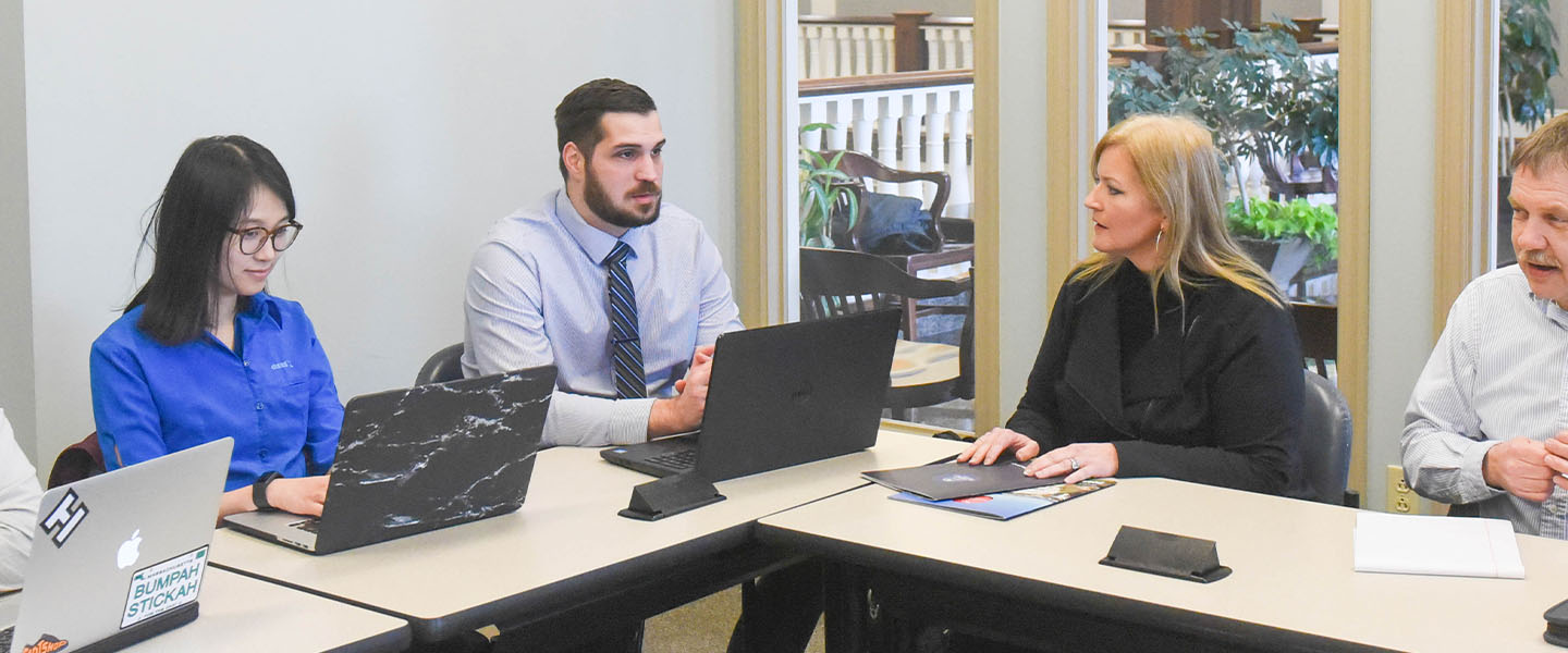 Pharmacy students having a discussion in a small group