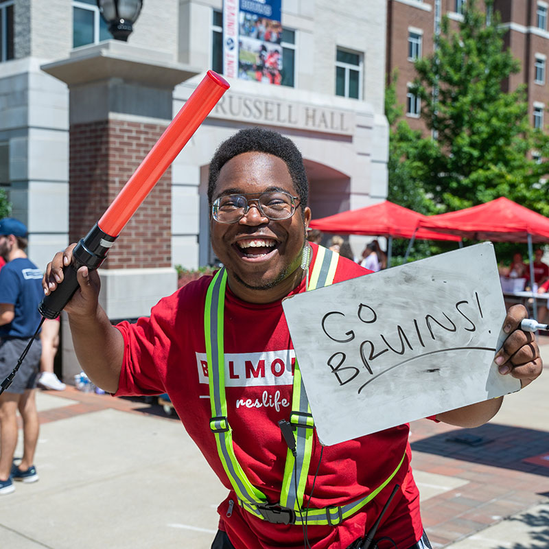 A student holding a sign that says Go Bruins on move in day