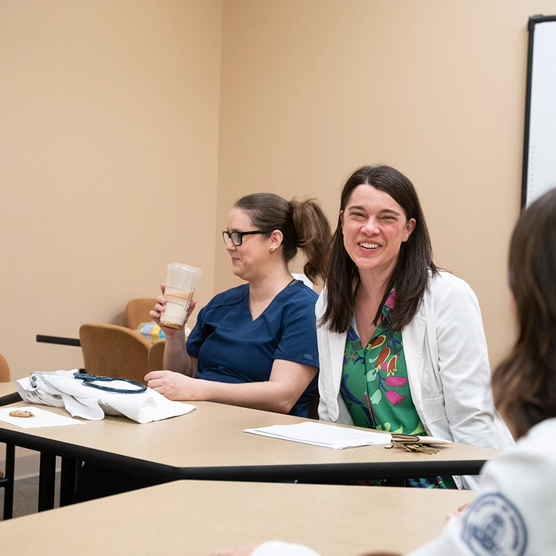 Belmont University healthcare students engaging in a classroom discussion, smiling and collaborating.