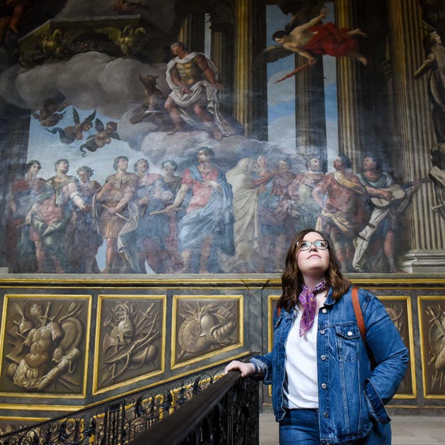 Belmont abroad student looking up at the painted walls around her in London