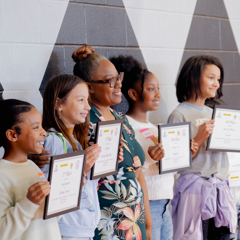 poetry contest winners holding their winning certificates