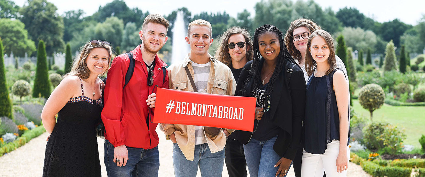 A group of students holding a sign that reads #BelmontAbroad