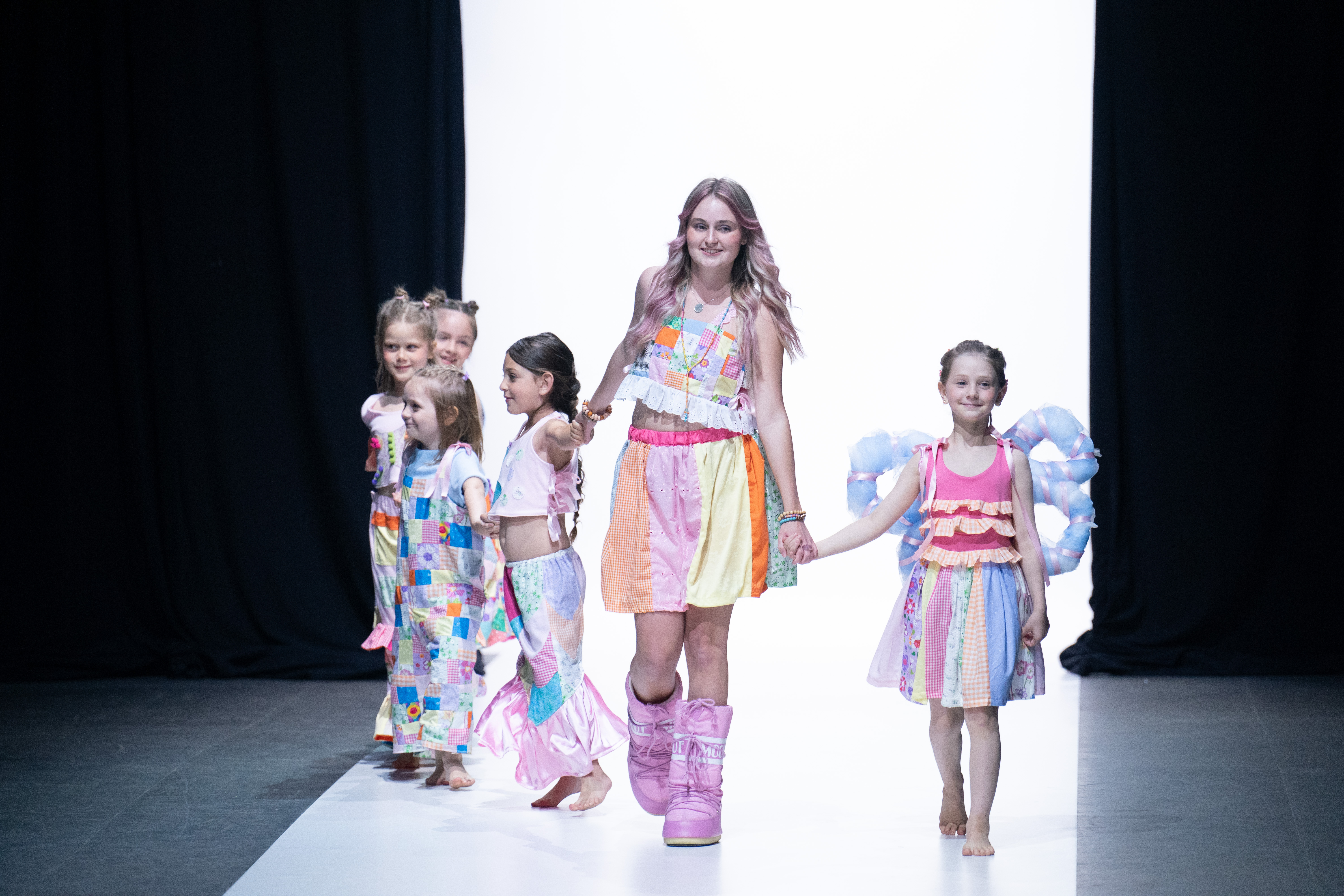 Designer showcases children's wear with kid models down runway
