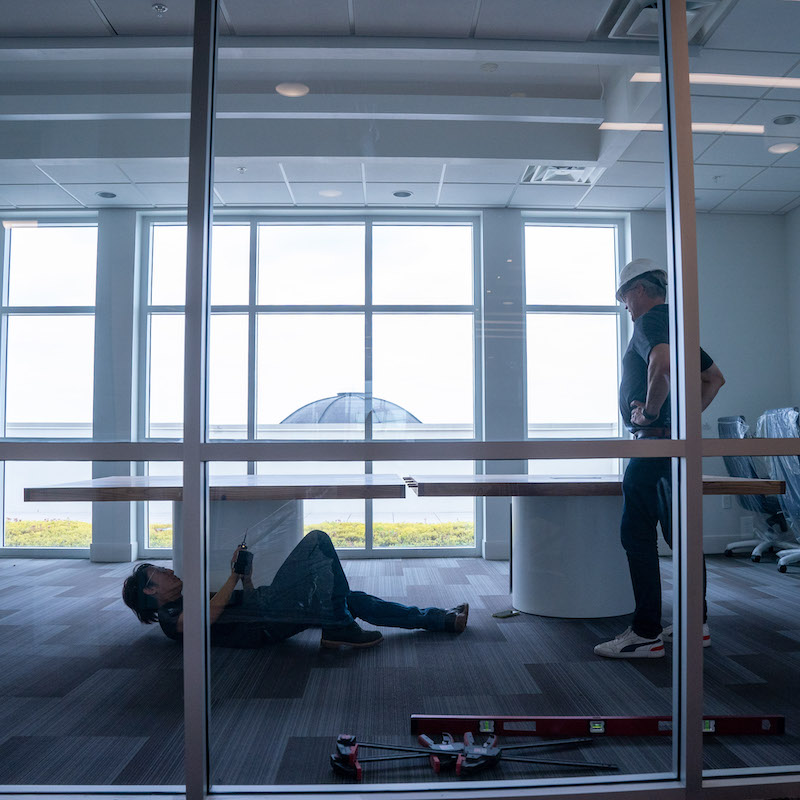 Putting table together in sixth floor conference room.