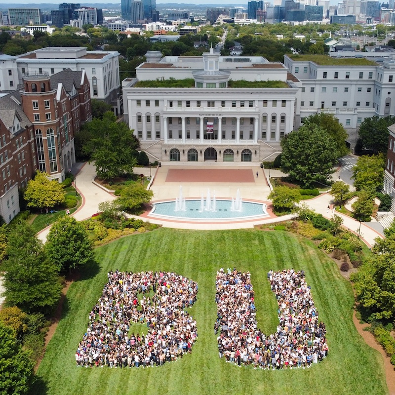 students spell out "BU" on campus lawn