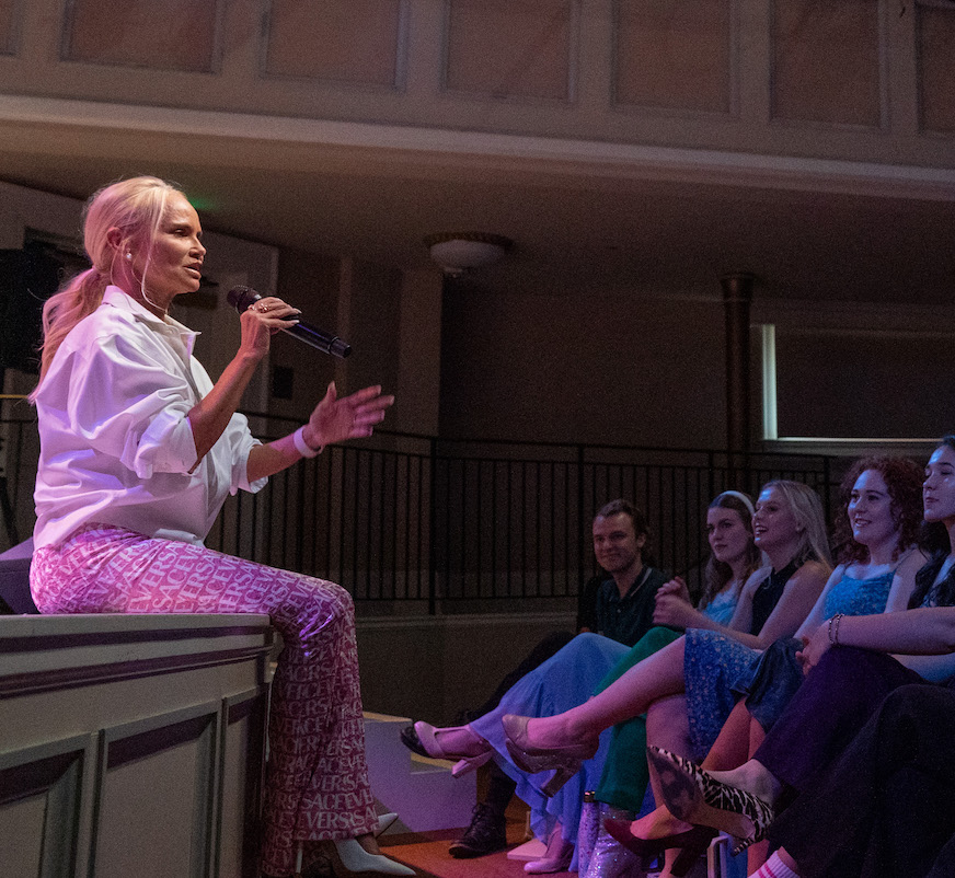 Kristin sits on edge of stage for Q
