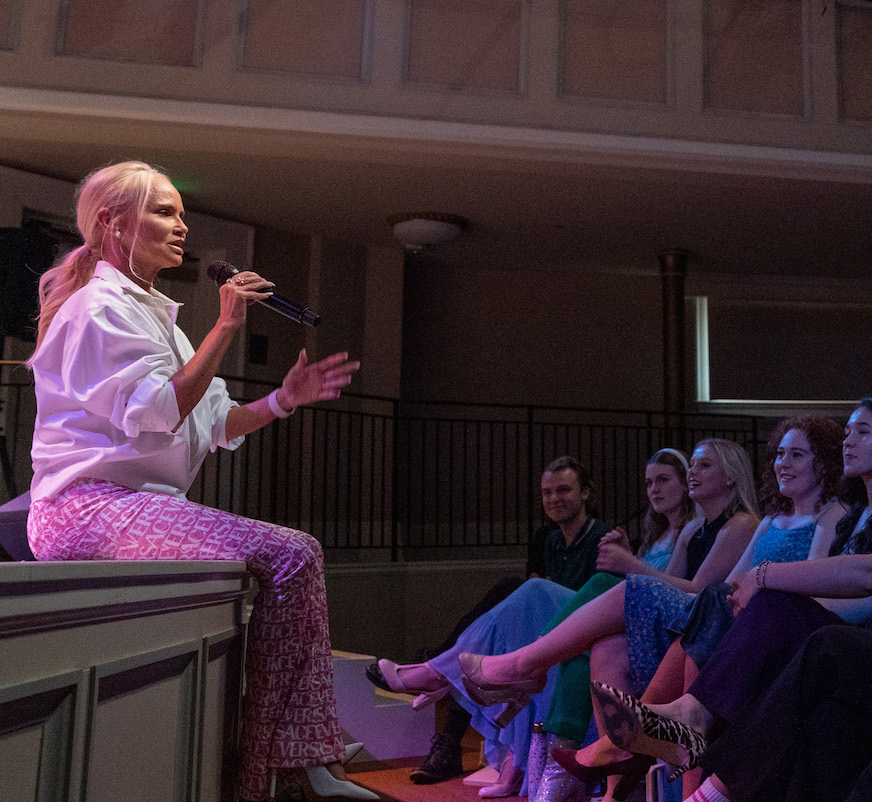 Kristin sits on edge of stage for Q