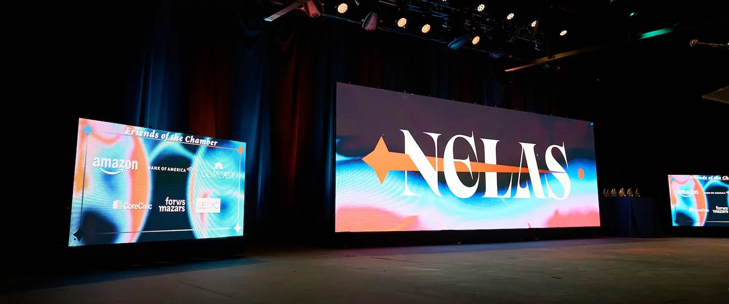 Stage at NELAS Ceremony with screen of sponsor