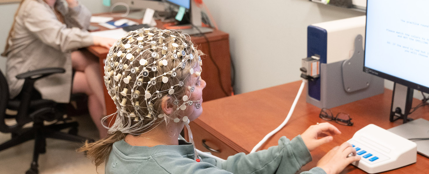 Psychology students completes test while wearing EEG