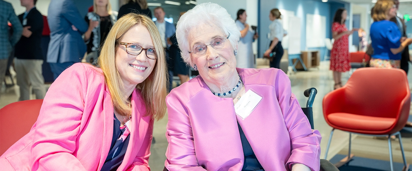 A photo of two women seated indoors