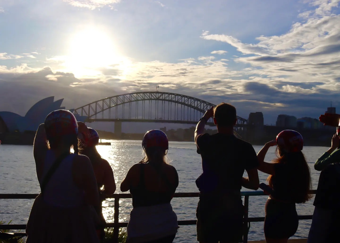 Silhouetted students with the Sydney Harbour Bridge in the background at sunset