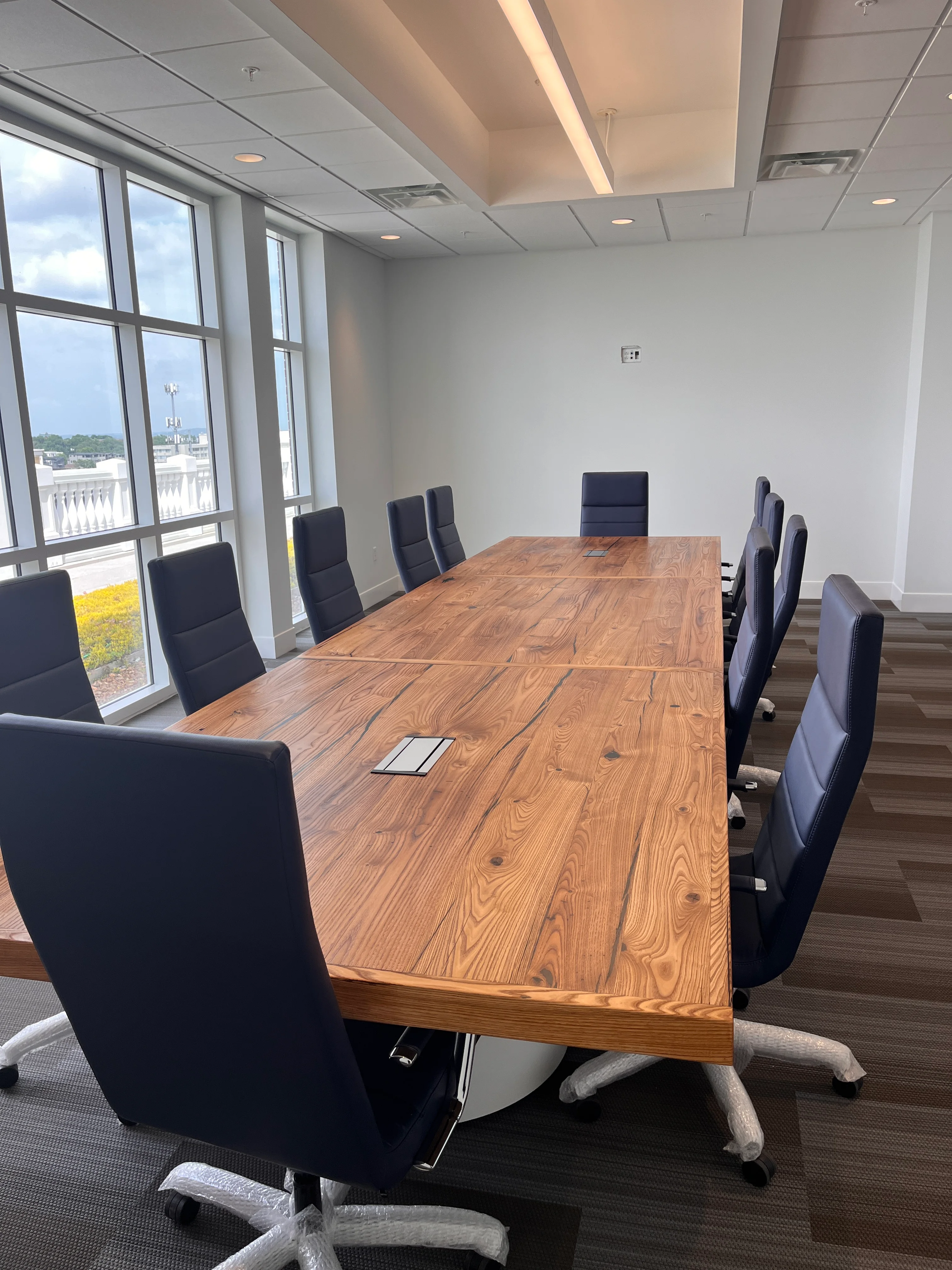 Photo of the chestnut table with chairs lined up around it