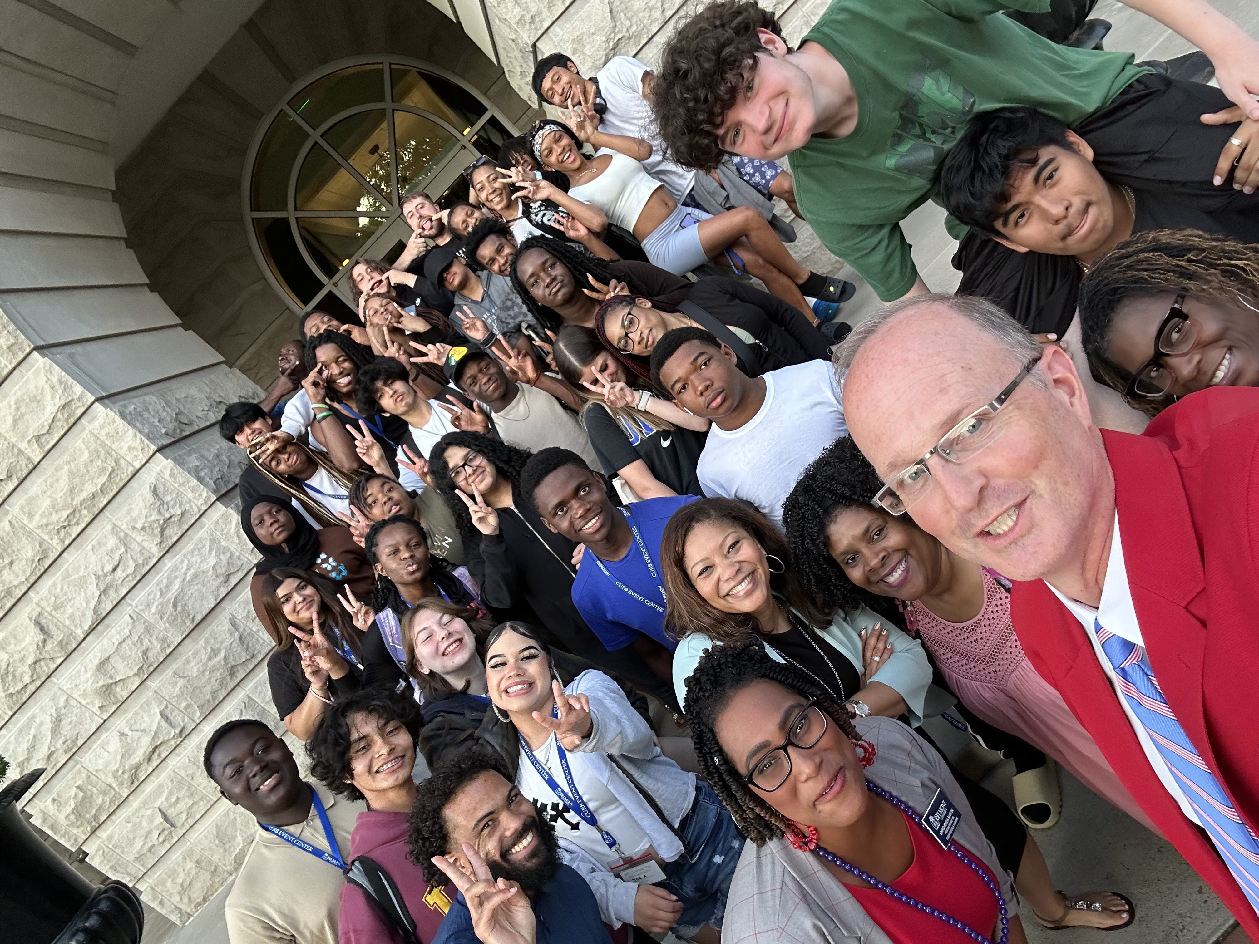 Dr. McIntyre poses with MNPS students outside of the McWhorter building