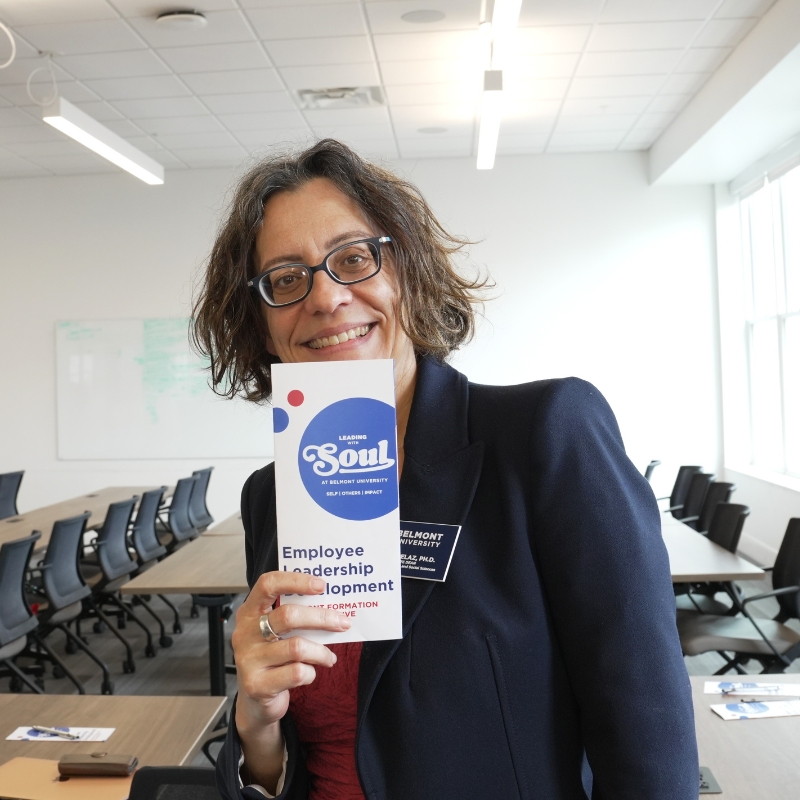 Natalia Pelaz smiles with "Leading with SOUL' pamphlet