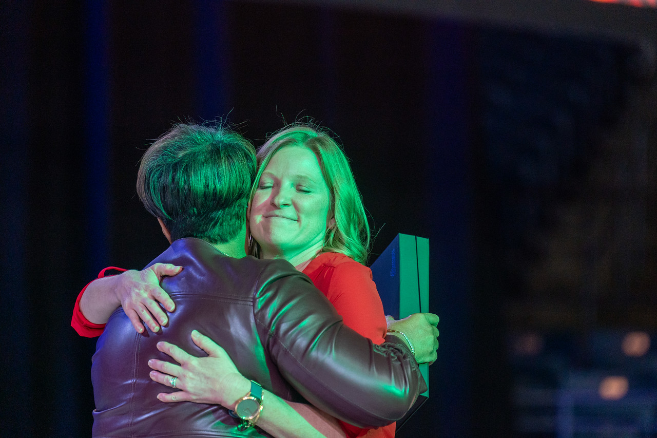 Renee hugging Susan West when accepting her award