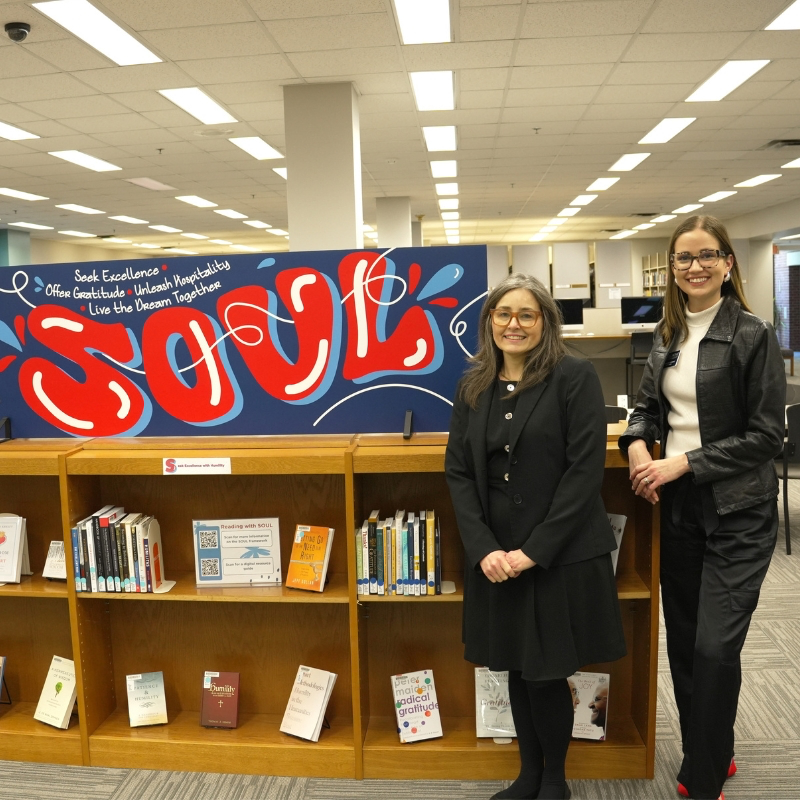 Caroline and Sue smiling in front of SOUL display