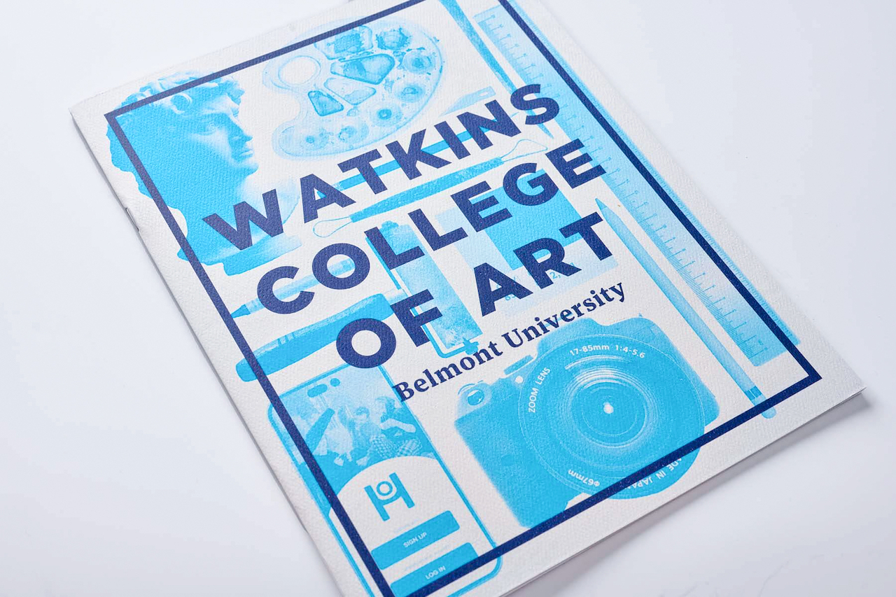 The image shows a publication or brochure titled "WATKINS COLLEGE OF ART" with "Belmont University" beneath it. The design features blue artistic elements including what appears to be paint splatters, a camera lens, and possibly an artist's palette against a white background with a dark blue border. The layout suggests this is promotional material for the art college at Belmont University, featuring visual motifs related to photography and visual arts.