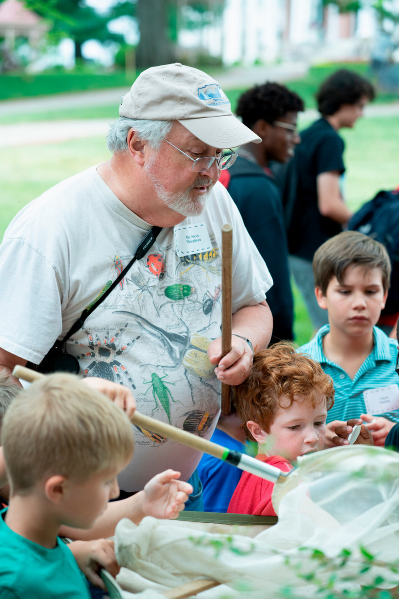 Dr. Murphree talks with campers about their bug catches