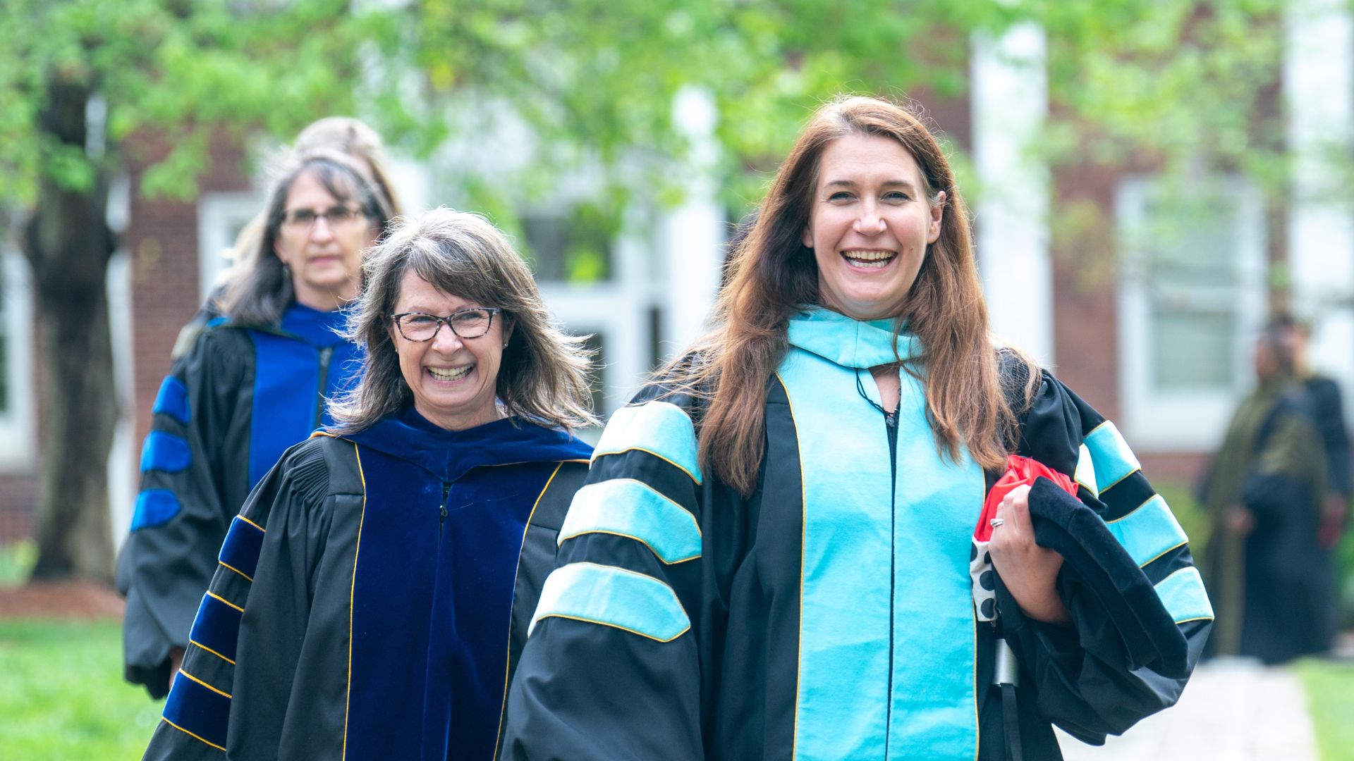 Faculty members smiling