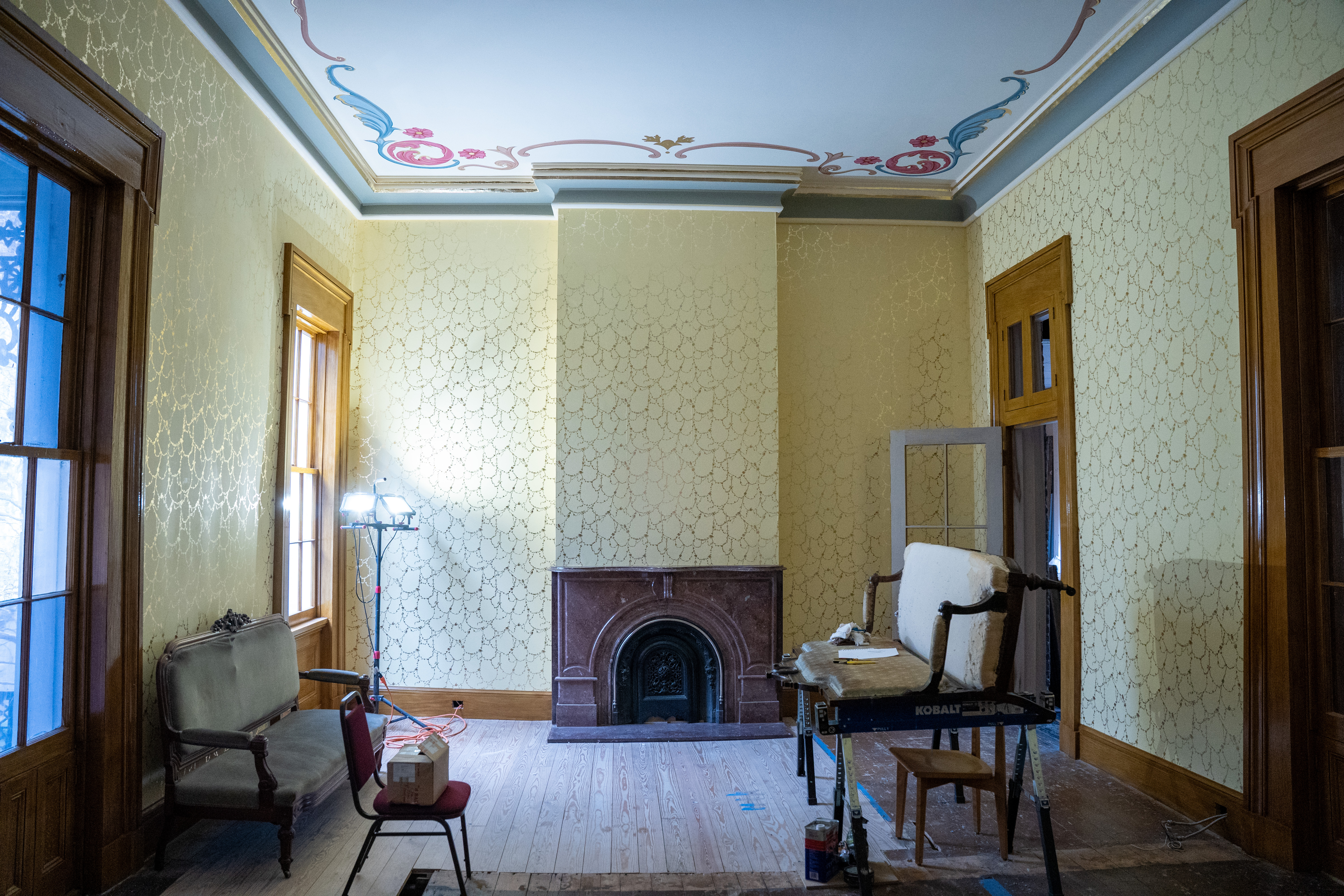 full shot of the billiard room, showcasing the new wallpaper and the mantel