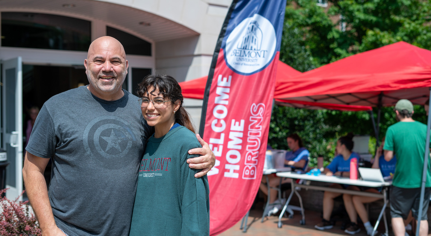 Dad and daughter outside a Belmont building on campus