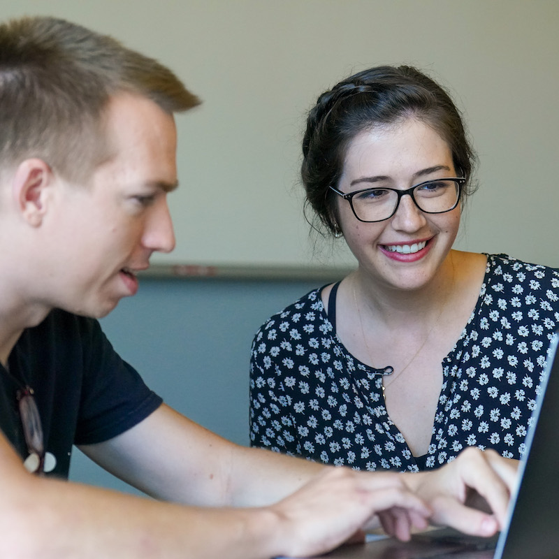 Davis works with a student on computer