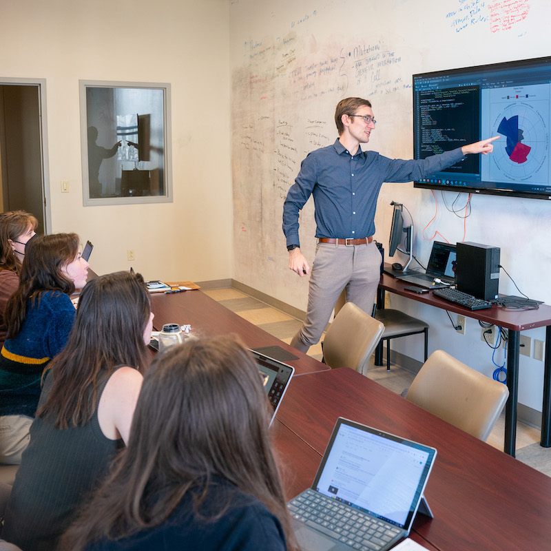 Dr. Best showing students something on screen