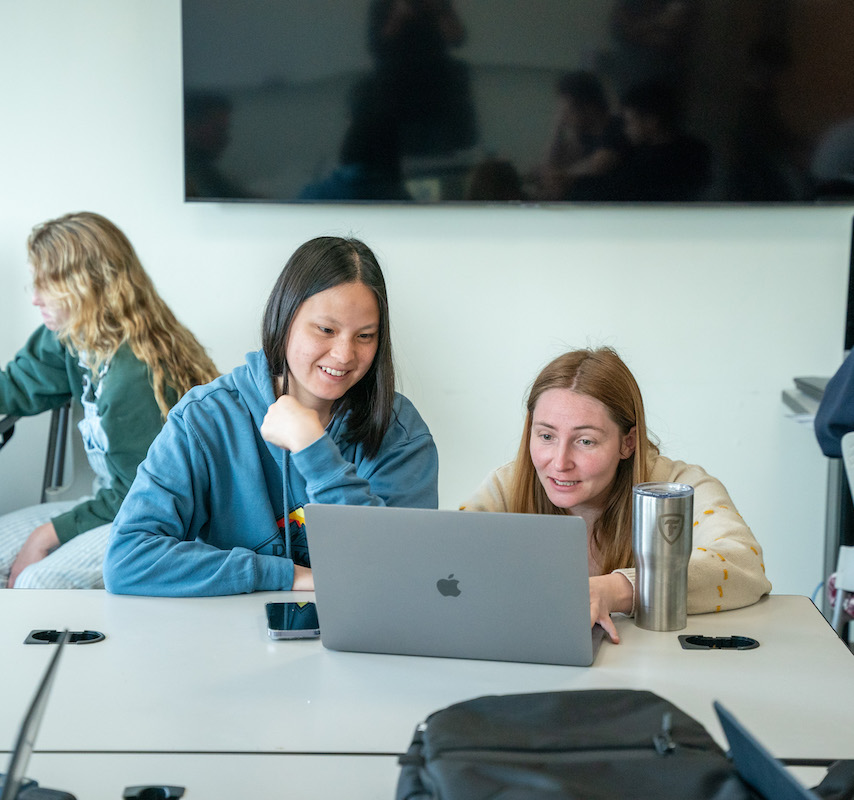 two students working on a computer