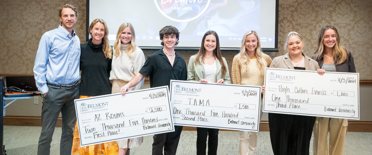 Winners of Buntin Pitch Competition pose with giant checks and judge panel